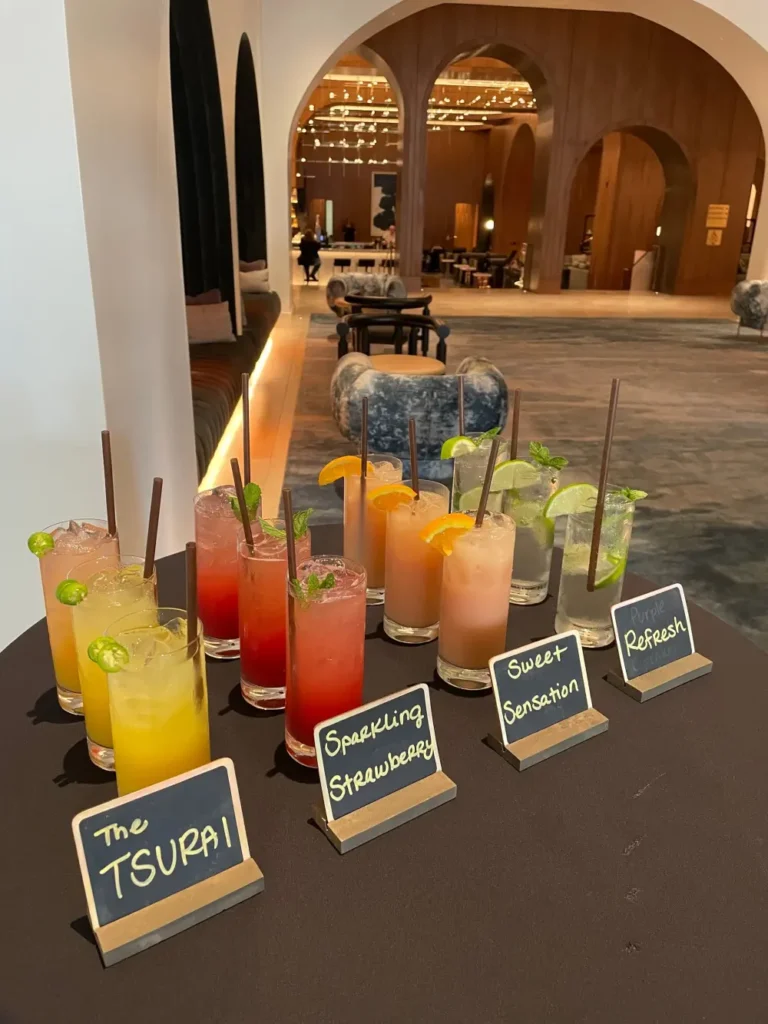 Summer mocktail bar setup with colorful drinks and garnishes