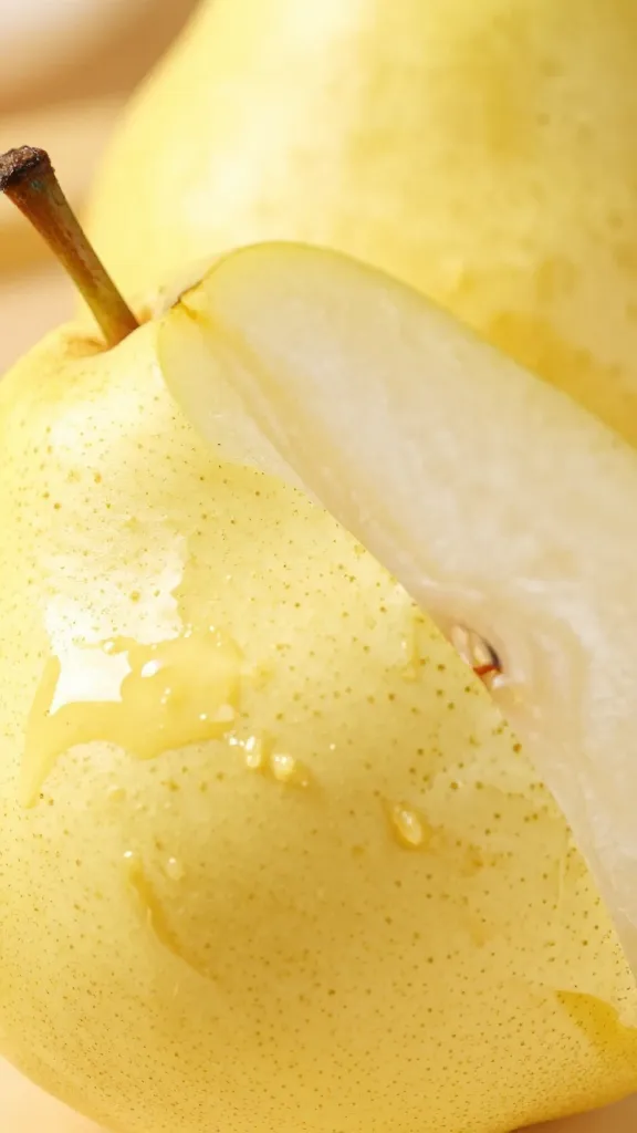 closeup of bosc pear sliced and butter-glossed
