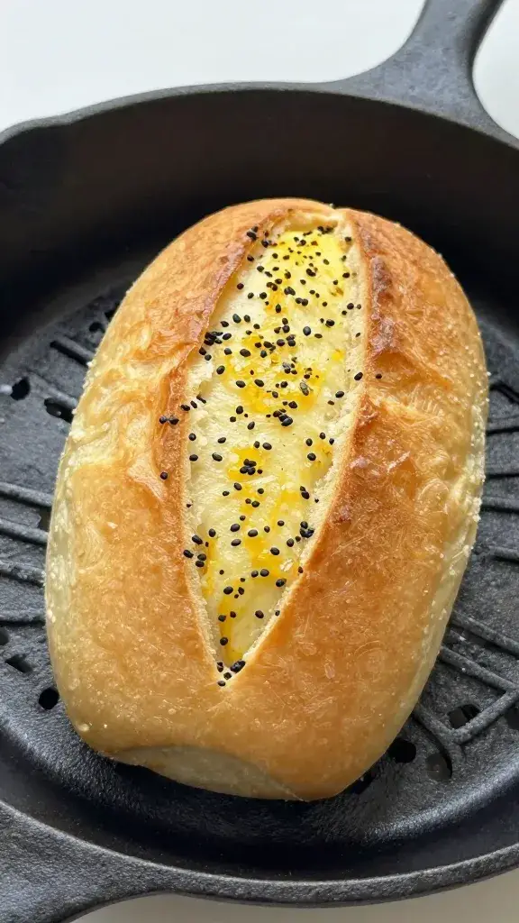 single pull-apart Hawaiian roll garlic bread in cast-iron pan