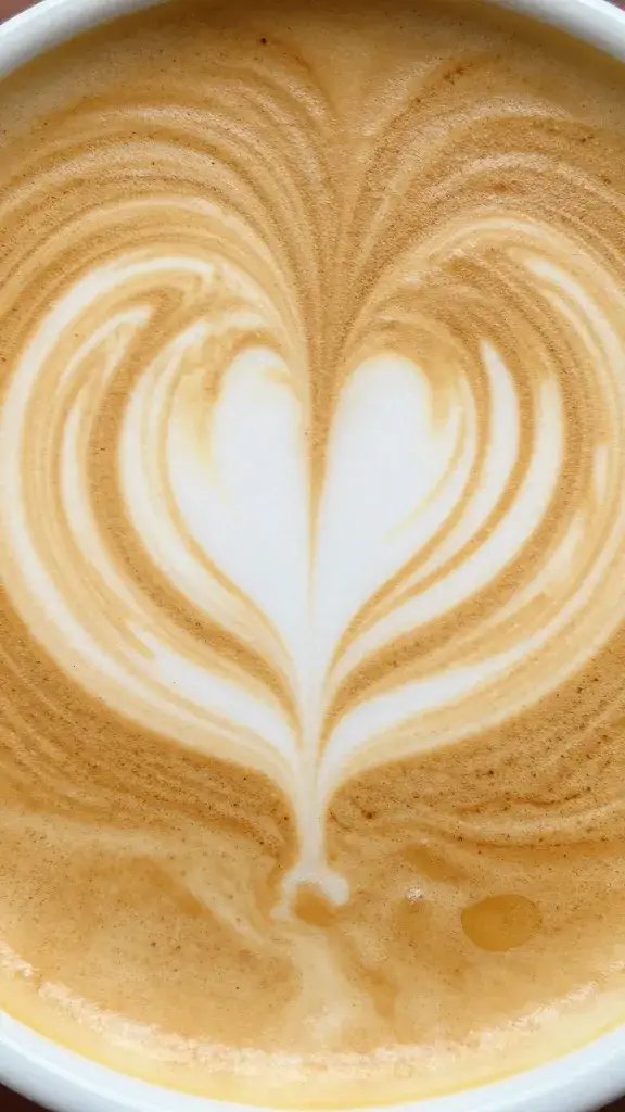 latte art heart reflected in maple syrup surface, macro