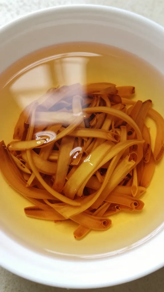 closeup bowl of ginger scallion oil, glossy surface