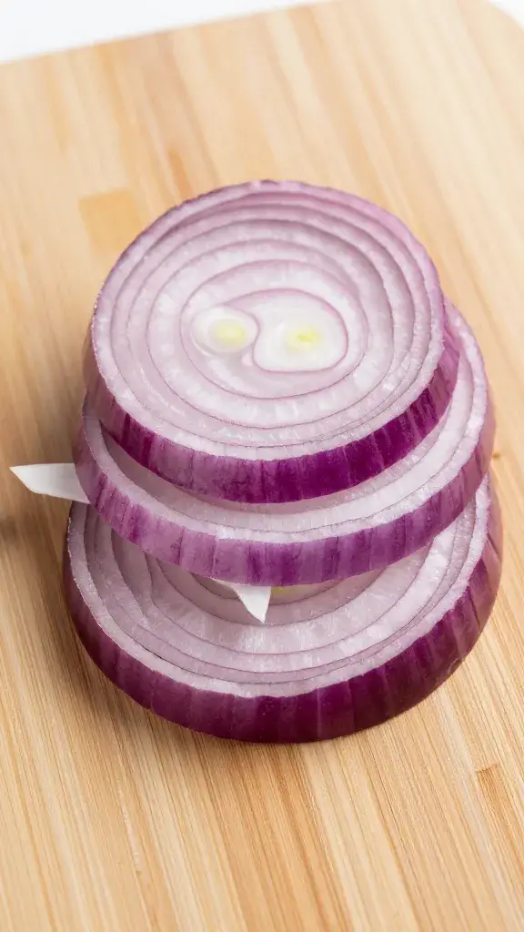 chopped red onion for salad on small cutting board