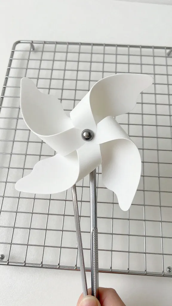 flaky pinwheel held with tongs over wire rack