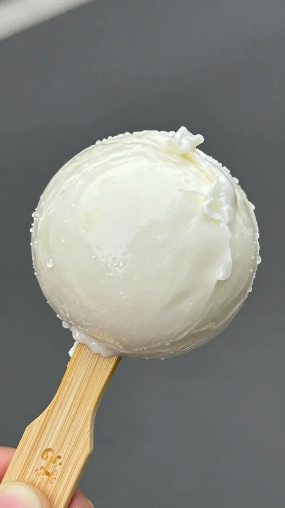 single ciliegine mozzarella ball on bamboo pick, glossy