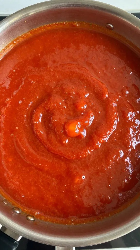 Saucepan simmering tomato-free BBQ sauce, overhead