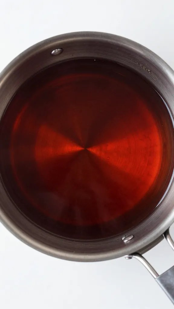 saucepan of reducing cherry cola syrup overhead