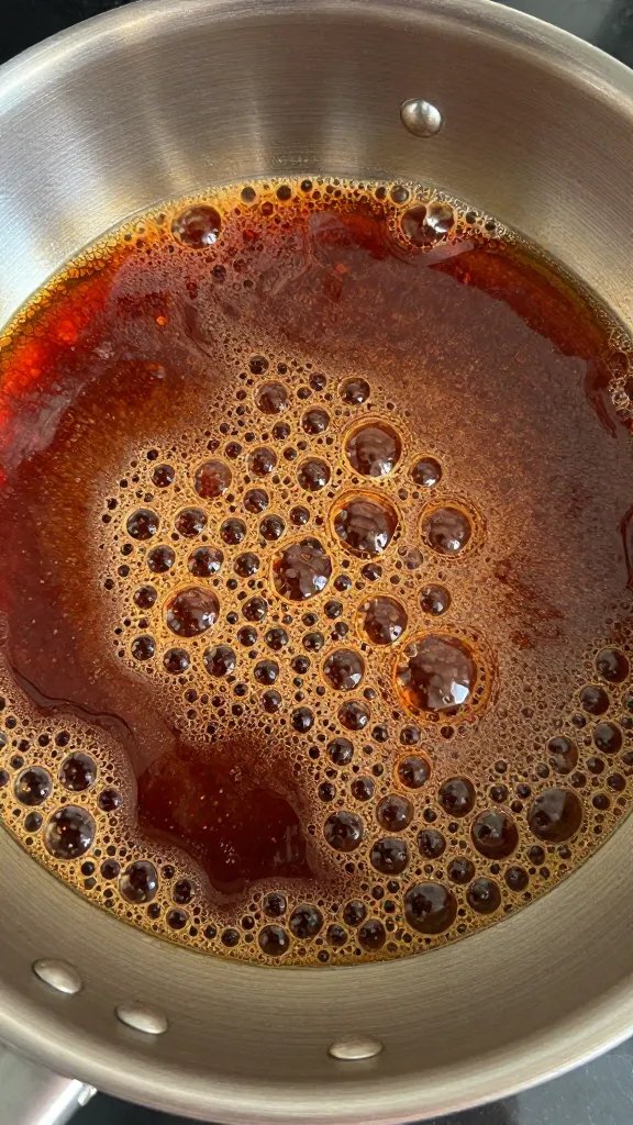 saucepan of reduced barbecue glaze with visible bubbles