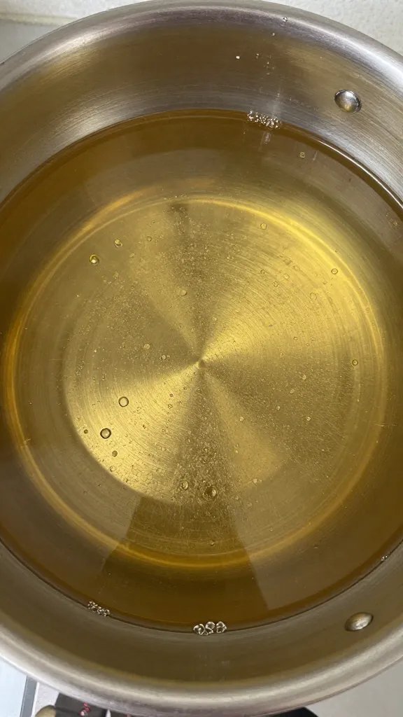 saucepan of simple syrup with visible sugar crystals