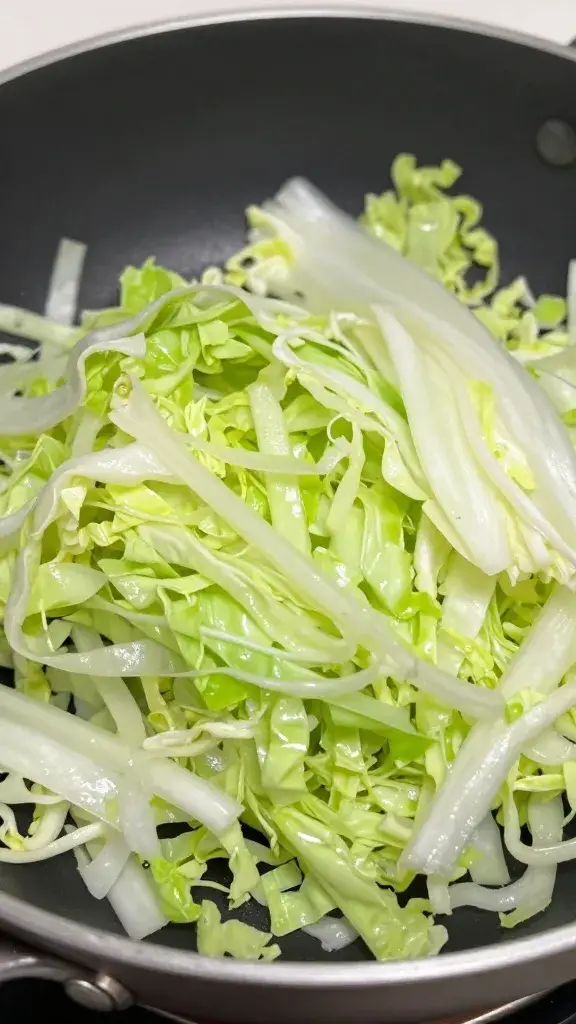 Food-safe hotel pan with undressed shredded cabbage, closeup