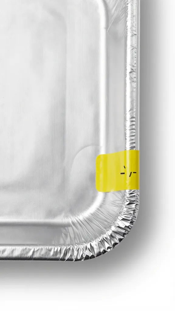 aluminum foil–covered tray corner with labeled time sticker