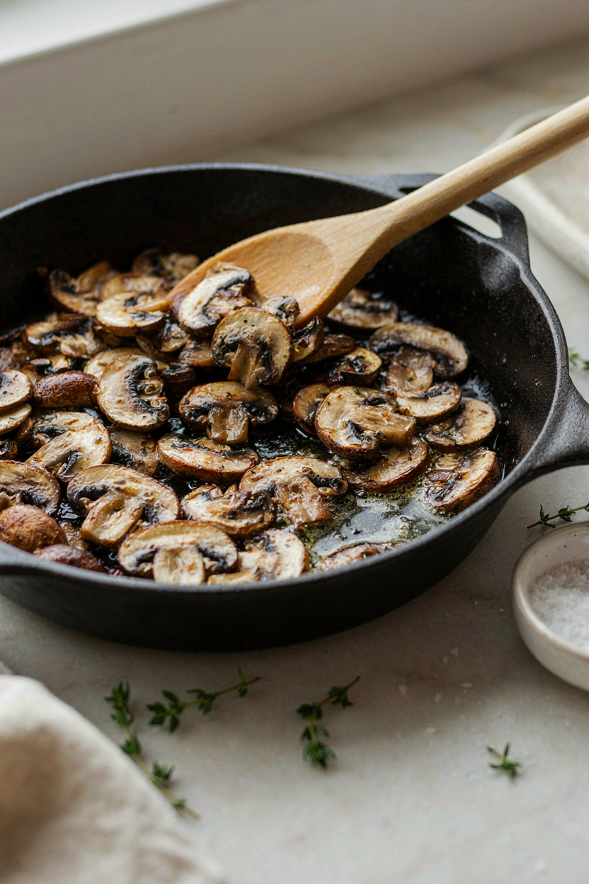 Mushrooms browning in large skillet with butter