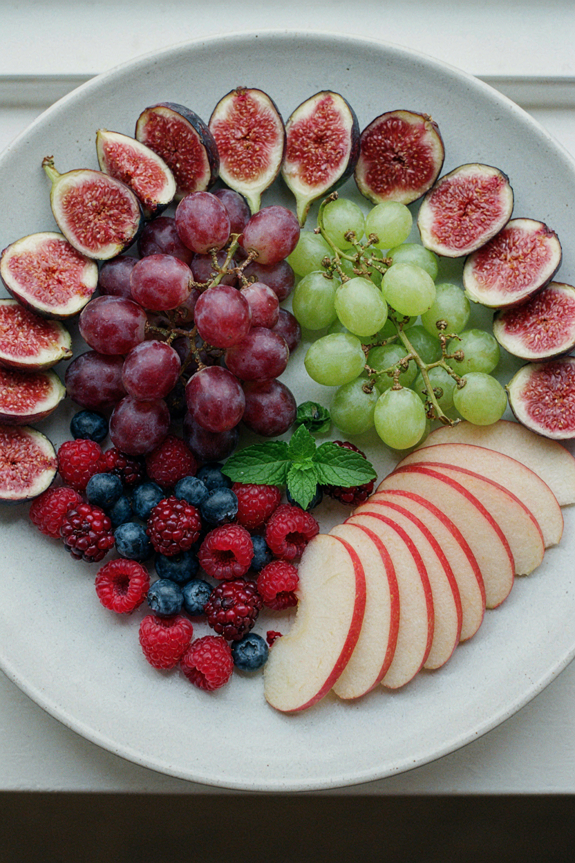 Fruit being arranged on platter by color