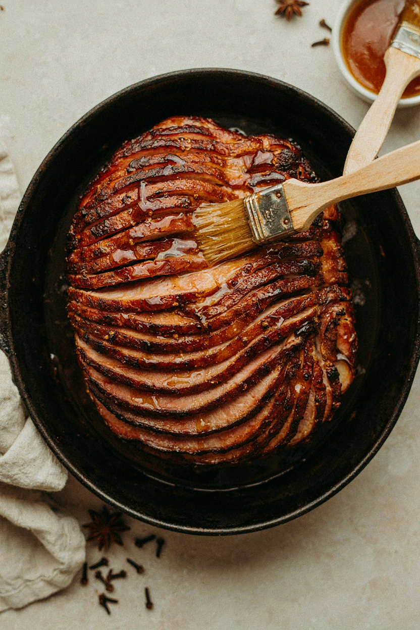 Glaze being brushed onto ham