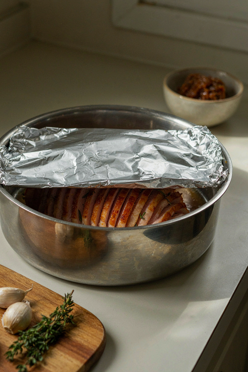 Ham in roasting pan covered with foil